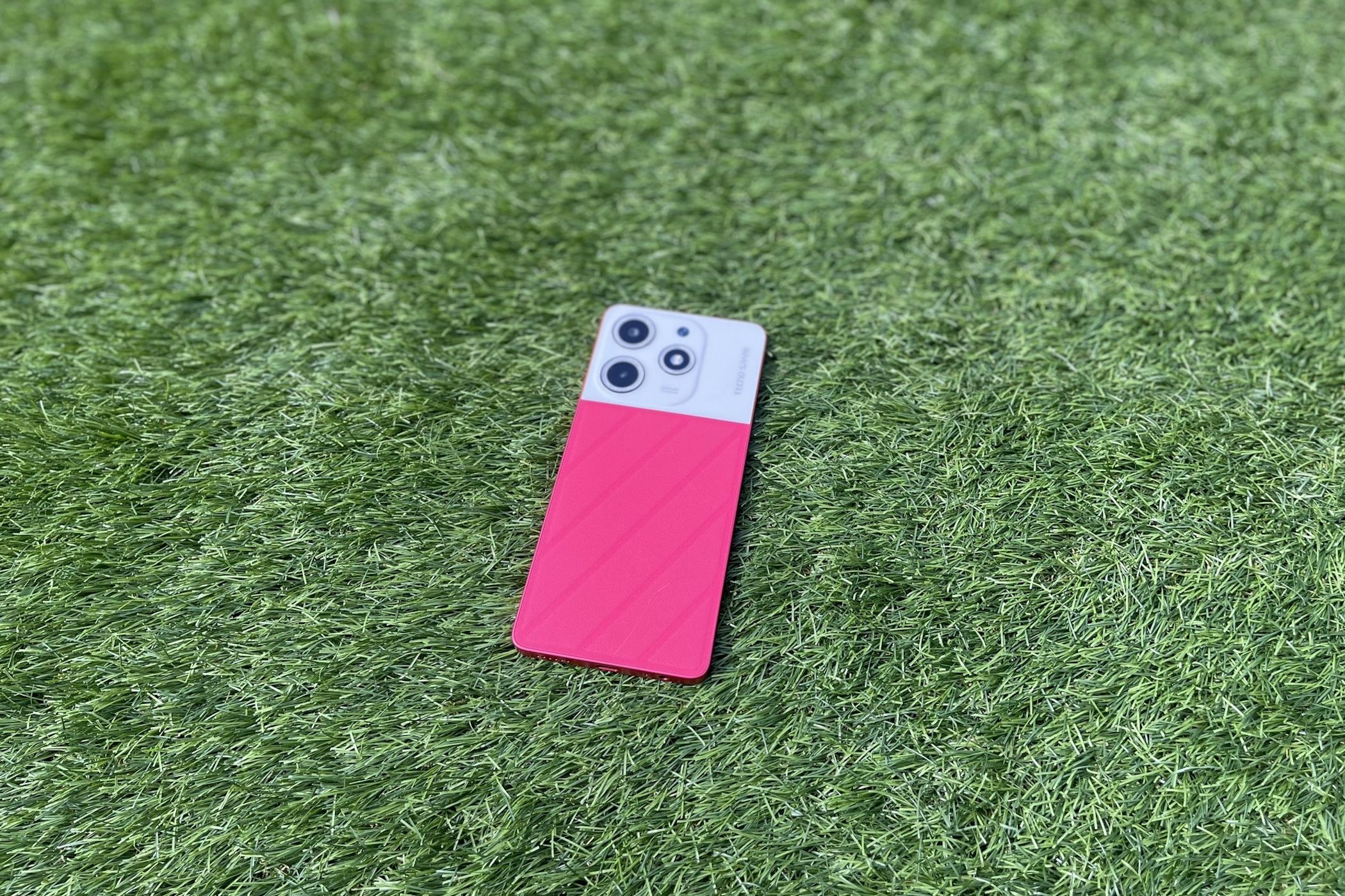 tecno spark 10 pro magic magenta outside on grass