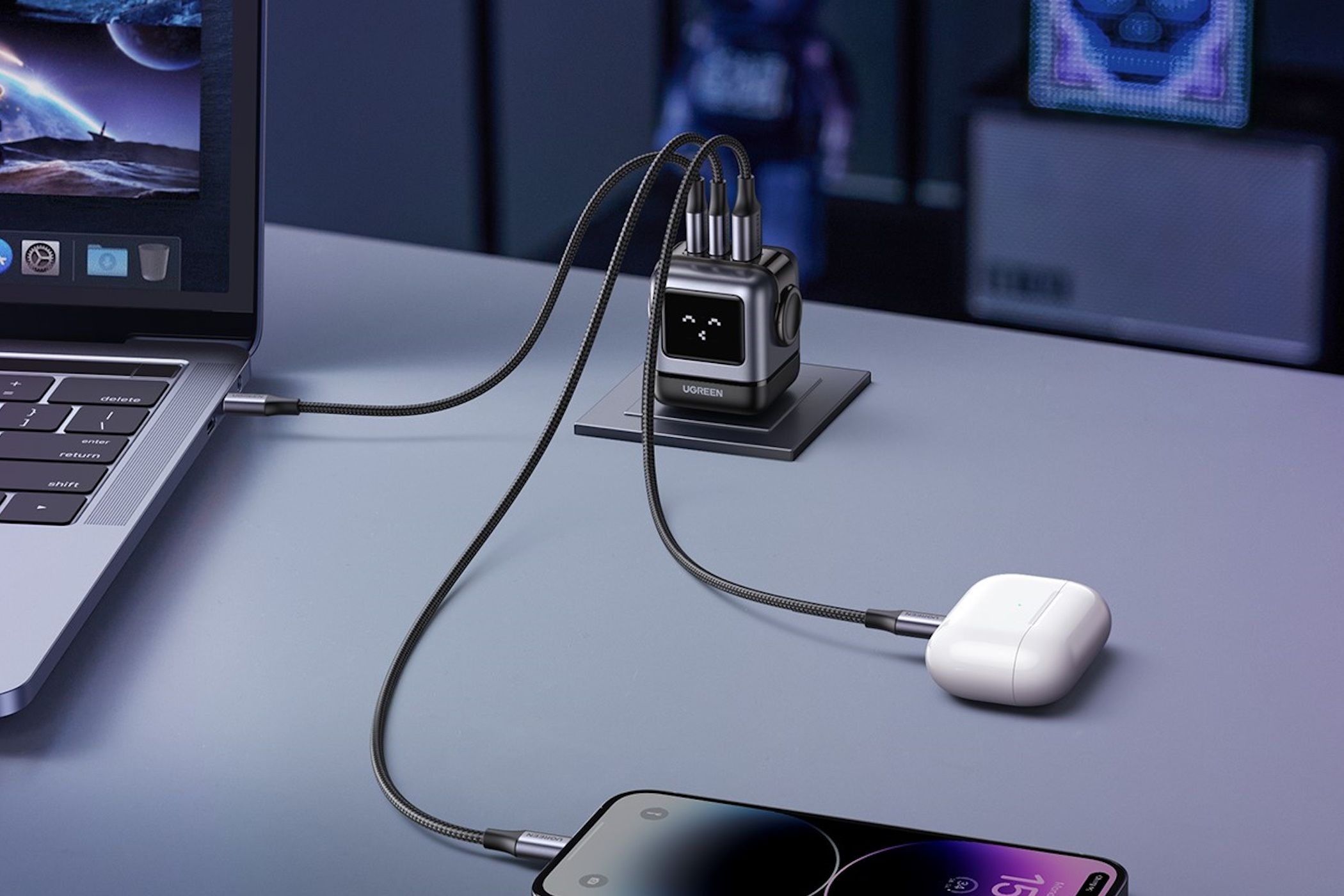ugreen rg charger charging devices on table including iphone, macbook, and airpods