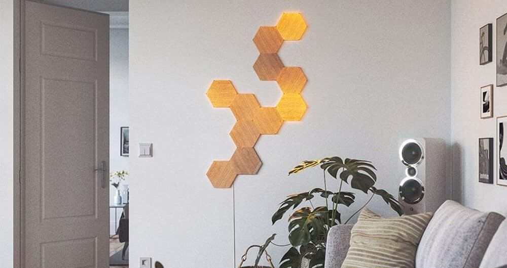 Nanoleaf hexagons on white wall with plants and a sofa to the side