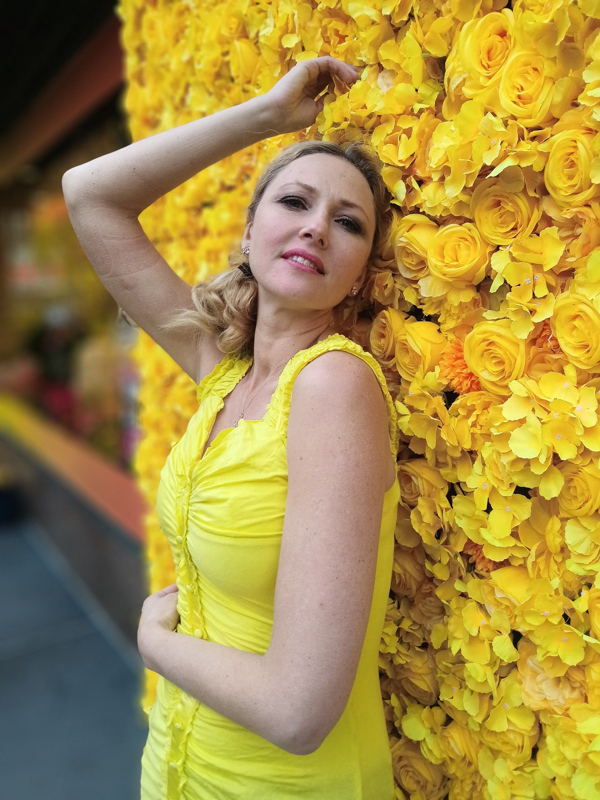 an image of lady with a flower wall background